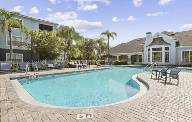 a large swimming pool in front of a house