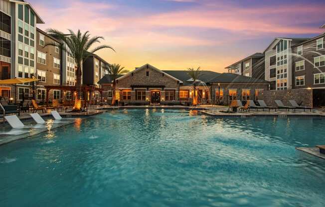 a large swimming pool with a sunset in the background