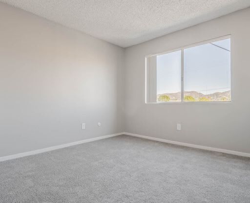 an empty room with a large window in it at The Arches Apartments, El Cajon, CA 92021