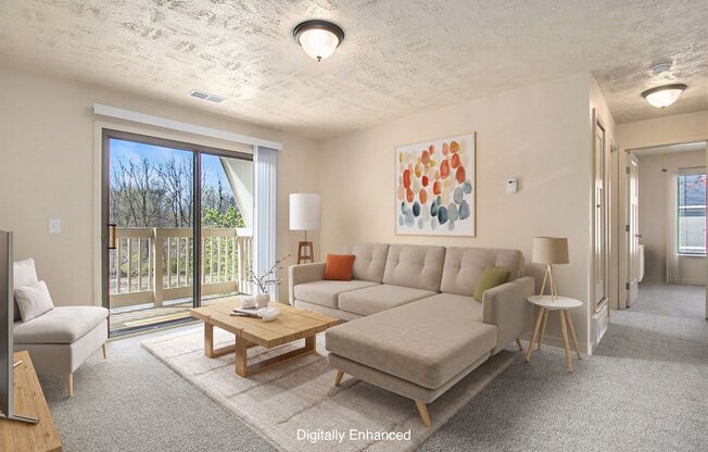 A living room with a plush carpeting and a slider to a balcony at Normandy Village Apartments, Michigan City, 46360