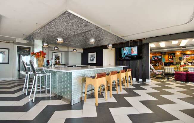 the lobby of a restaurant with a bar and chairs