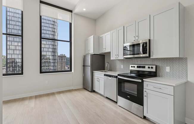 A kitchen with white appliances and cabinets.