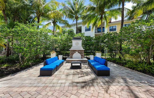 a courtyard with blue couches and a fountain