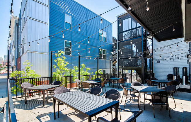 Community patio with tables and chairs on a sunny day