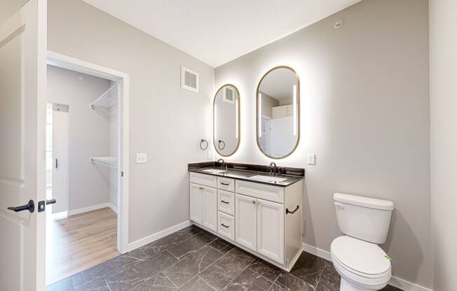 a white bathroom with a toilet and a sink