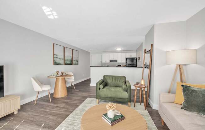 A living room with a green chair and a coffee table.