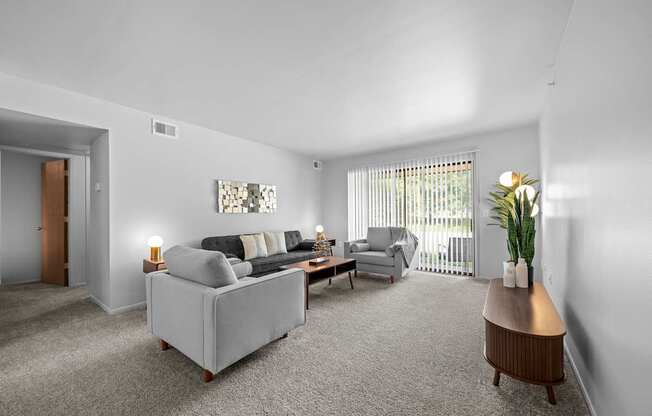 Living room with patio at Dover Hills Apartments in Kalamazoo