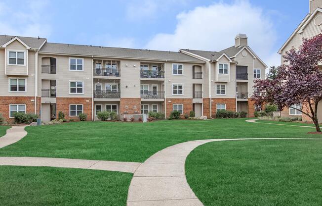 a large lawn in front of a brick building