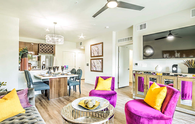 a living room and dining room with a table and chairs