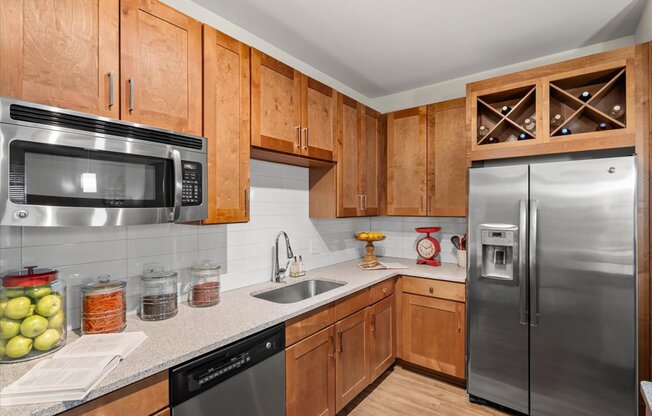 a kitchen with wooden cabinets and stainless steel appliances