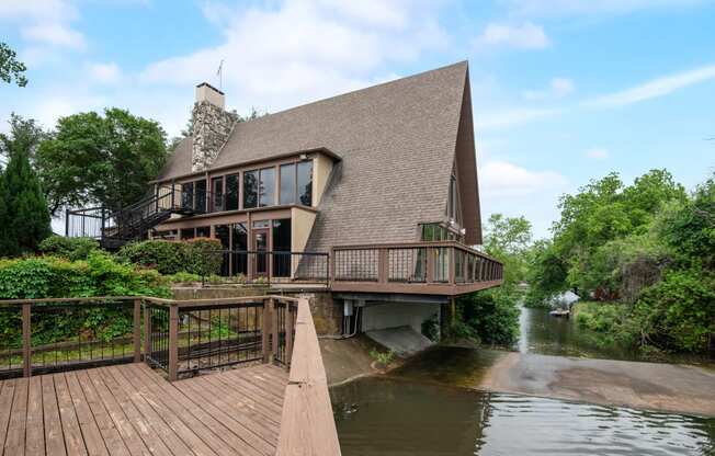 a house on the water with a wooden deck