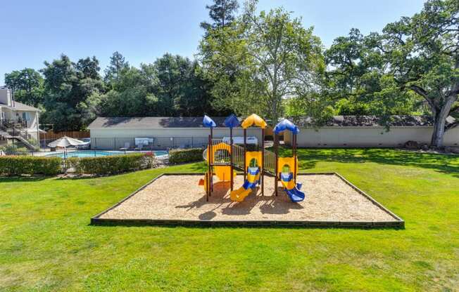 Playground with Sand, Grass and Apartment Exteriors