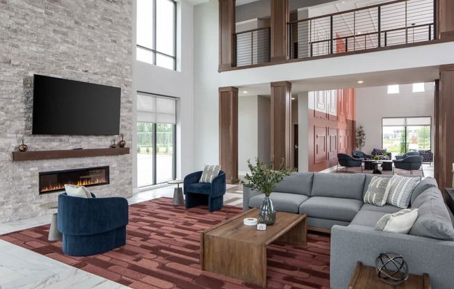 A modern living room with a fireplace and a television above it.