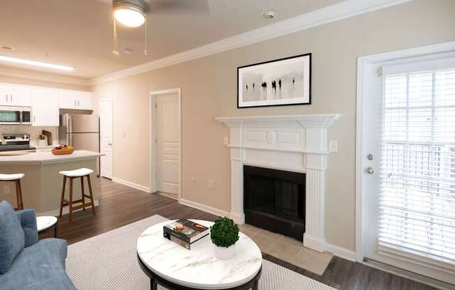 A living room with a fireplace and a painting on the wall.