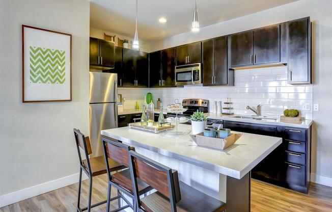 a kitchen with a large center island next to a stove top oven