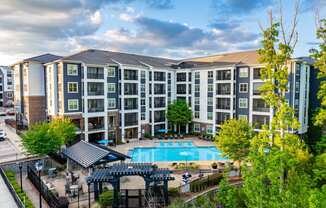 an aerial view of an apartment building with a swimming pool