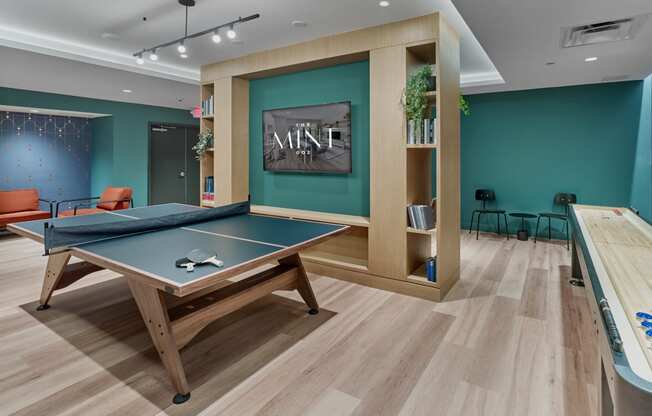 Game room at The Mint Rahway with ping pong and foosball tables, ideal for resident entertainment, close to Rahway Train Station and Merck Pharmaceutical.