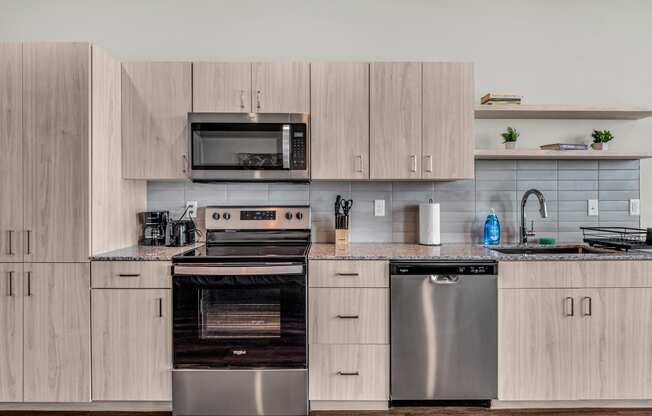 a kitchen with stainless steel appliances and wooden cabinets