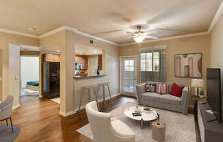 A living room with a grey couch, a coffee table, and a television.