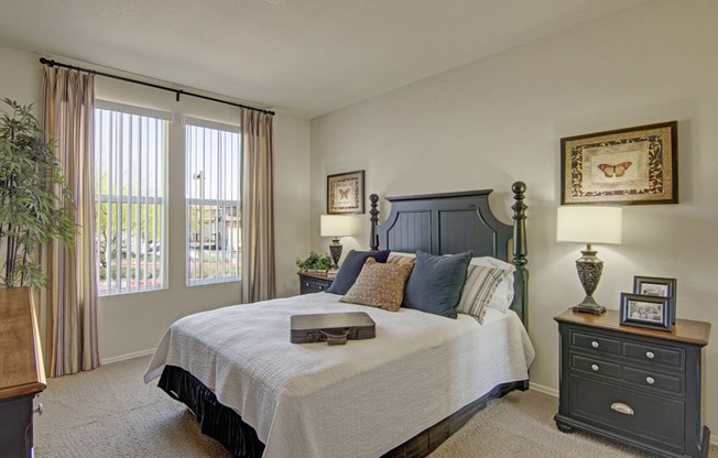 a bedroom with a large bed and two night stands with lamps