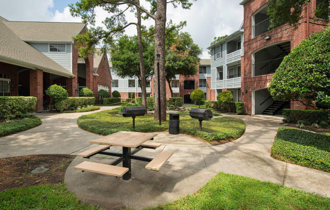our apartments have a spacious courtyard with a picnic table and grills at Veranda at Centerfield, Houston, 77070
