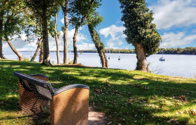 a park bench overlooking a body of water with boats