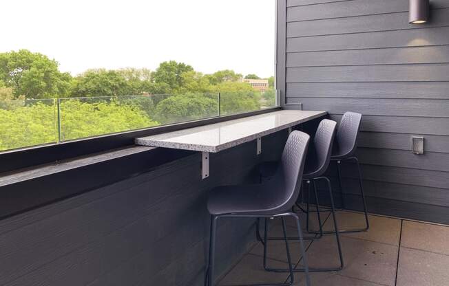 a long table on the sky deck with three chairs