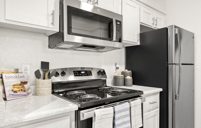 a stove top oven sitting inside of a kitchen