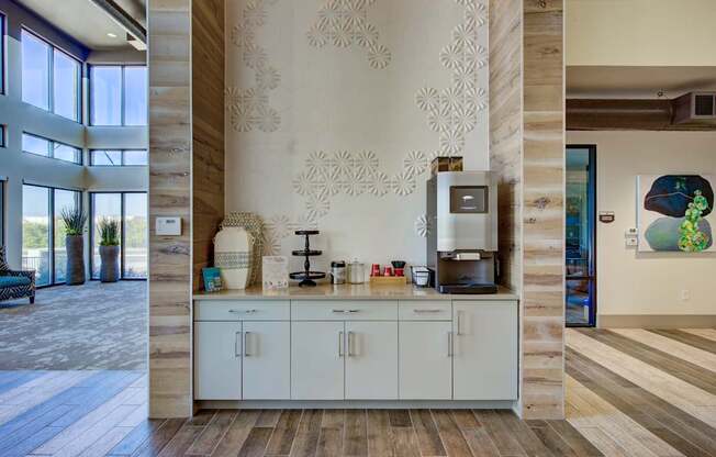 A kitchen area with a white counter and cabinets.