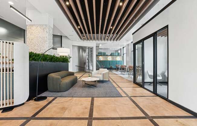 a lobby with a couch and chairs and a reception desk