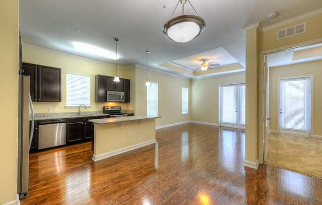 an empty living room with a kitchen in the background  at Alaqua, Florida