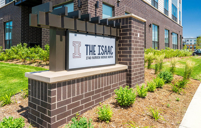 The brick Issac sign and apartments