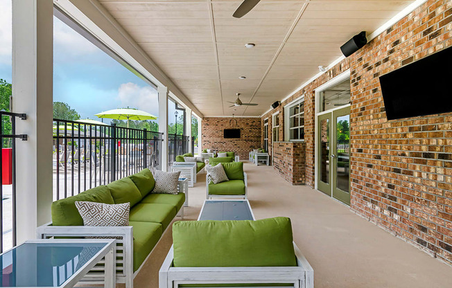 the preserve at ballantyne commons porch seating area with green couches and tables