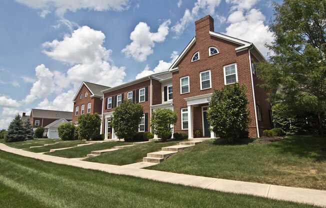 A red brick building with a white door and windows.