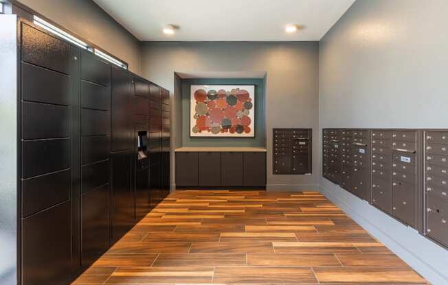 a lockers room with wooden floors and a painting on the wall