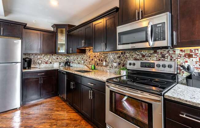 a kitchen with stainless steel appliances and wooden cabinets