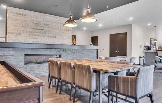 A modern dining room with a fireplace and wooden furniture.