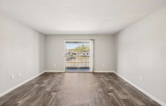 A room with a view of a balcony with a railing.