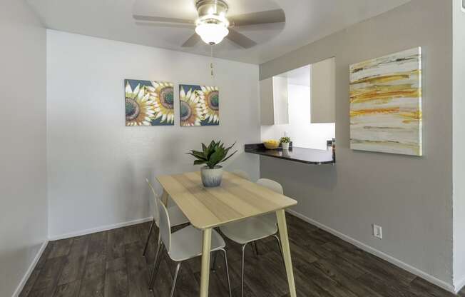 a dining room with a table and chairs and a ceiling fan