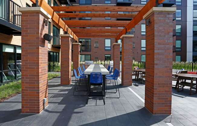 Outdoor courtyard complete with a variety of tables and a pergola.