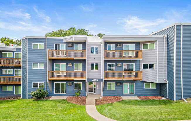 Apartment complex with a walkway in front.