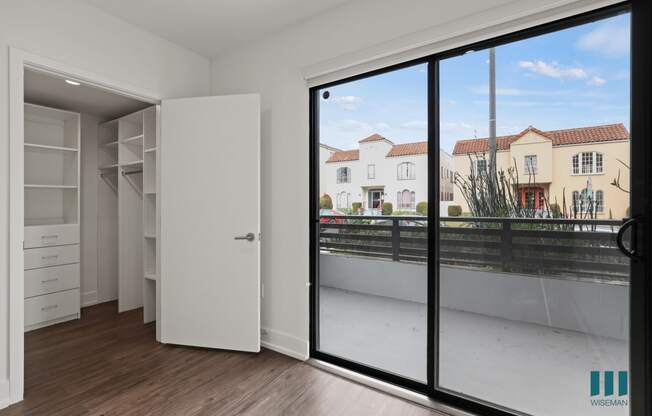 Bedroom with Walk-In Closet and Balcony Access