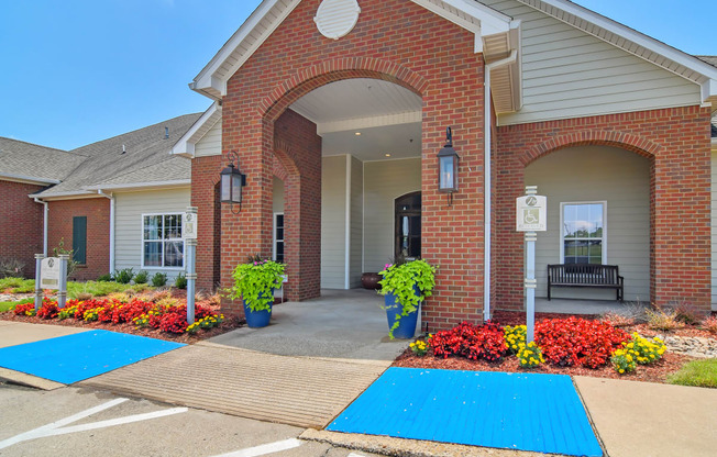 the entrance to a brick building with blue mats on the sidewalk