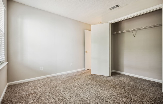 a bedroom with a closet and a window
