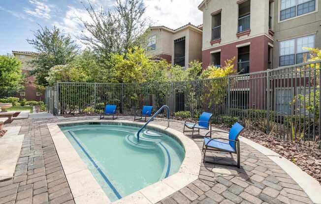 North Las Vegas, NV Apartments - Sonata Apartments - Soothing Spa With Beautiful Landscaping and Four Blue Lounge Chairs.