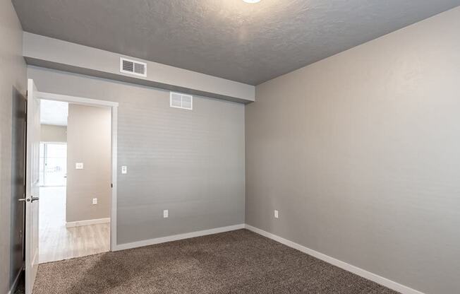 a bedroom with gray walls and carpet