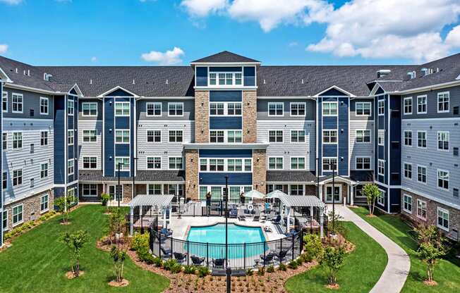 an aerial view of an apartment building with a swimming pool