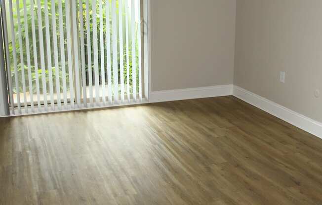 bedroom with wood floors and a sliding glass door at Renew Worcester, Massachusetts, 01602