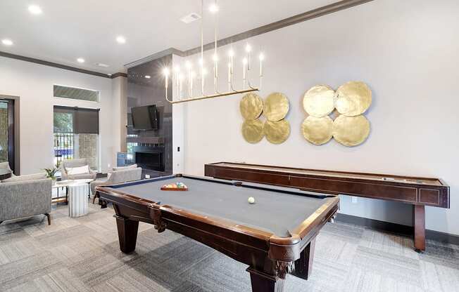 a rec room with a pool table and a tv