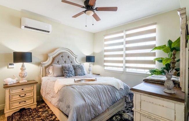 a bedroom with a bed and a ceiling fan